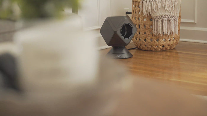 black heater and fan combo oscillating, tilting in a large room with it's heater and cooler fan remote